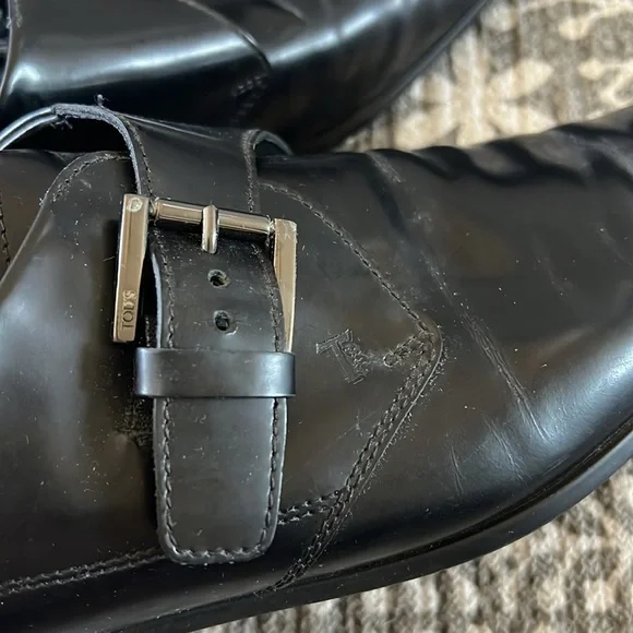 Tod’s black buckle loafers